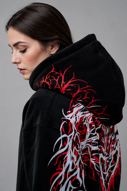 Black reflective hoodie with red tribal back graphic, worn by rider