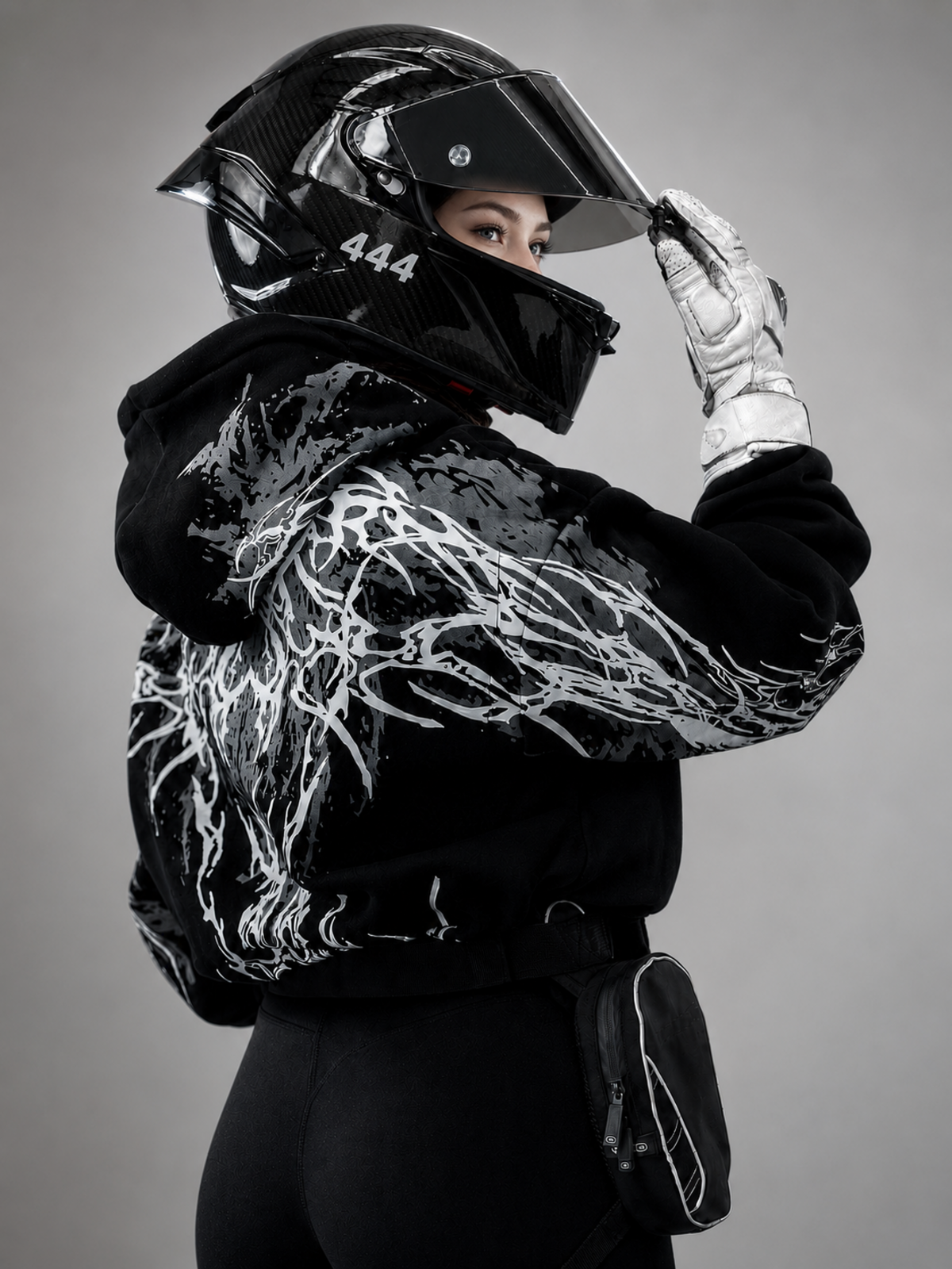 Black reflective hoodie with white tribal back graphic, worn by rider