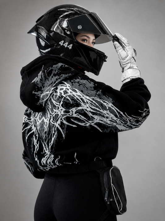 Black reflective hoodie with white tribal back graphic, worn by rider