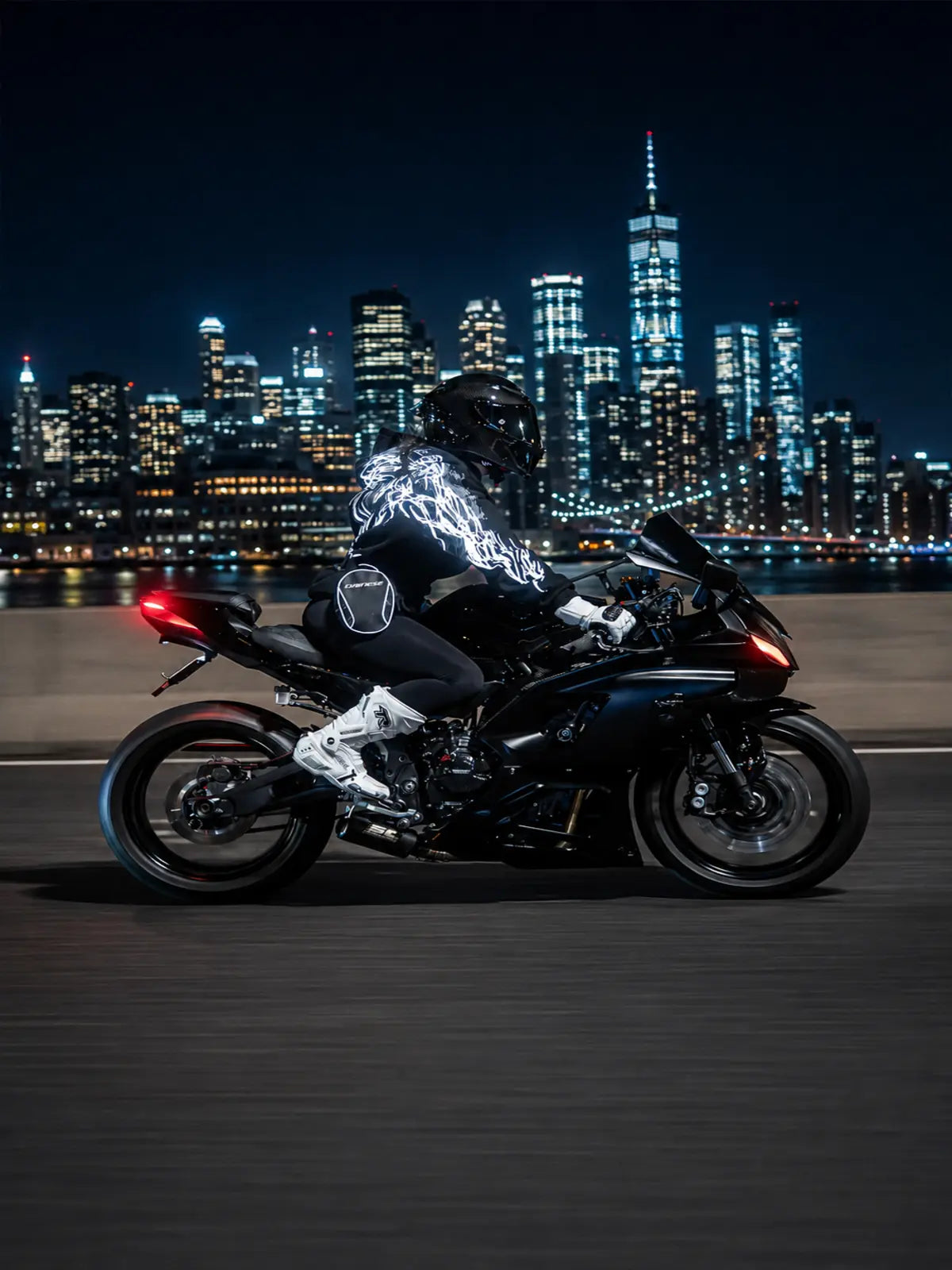 Black reflective hoodie with white tribal back graphic, worn by rider