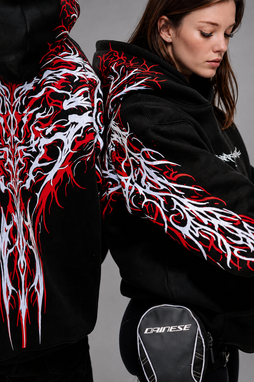 Black reflective hoodie with red tribal back graphic, worn by rider